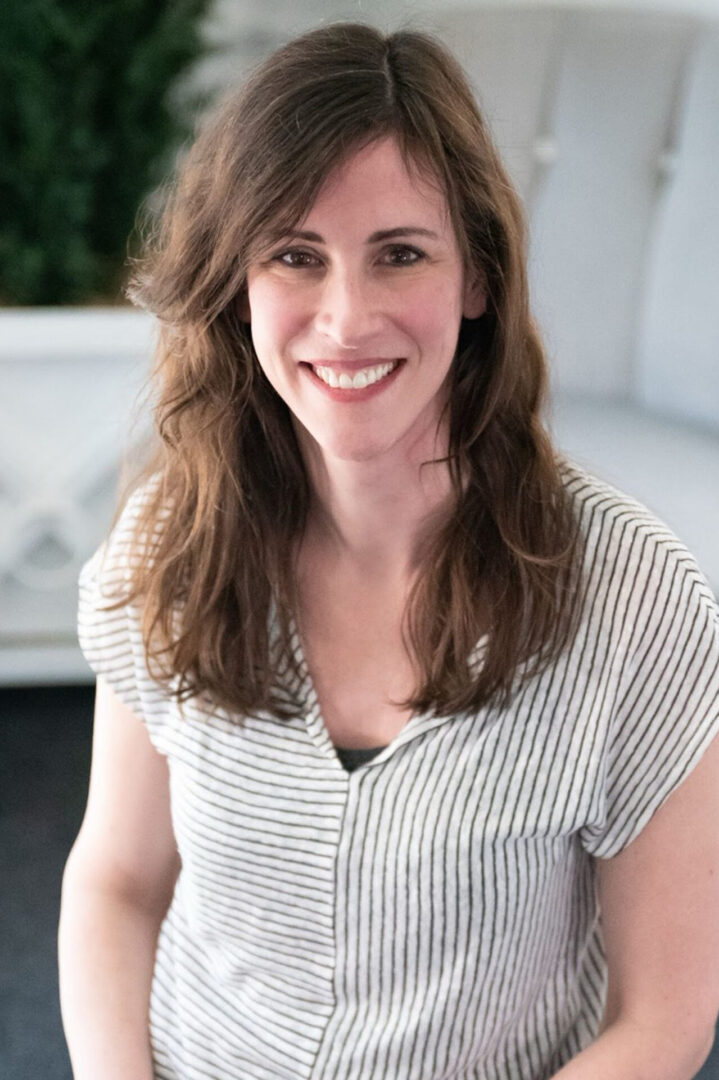 A woman with long hair and a striped shirt.