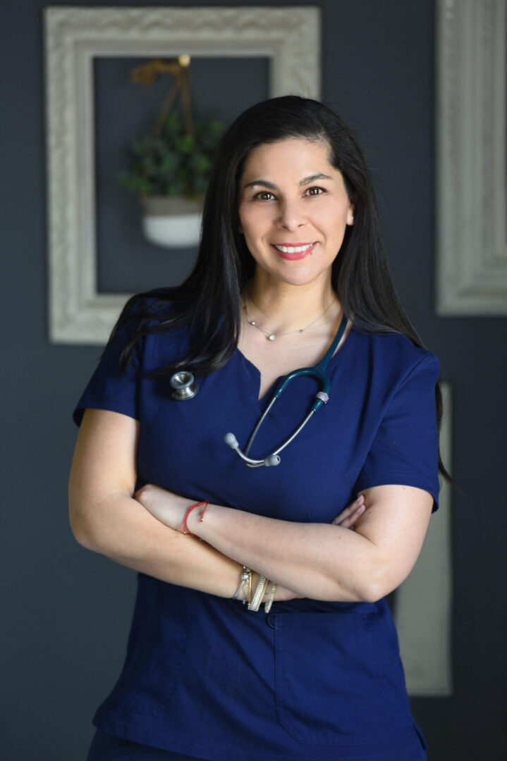 A woman in blue shirt with arms crossed.